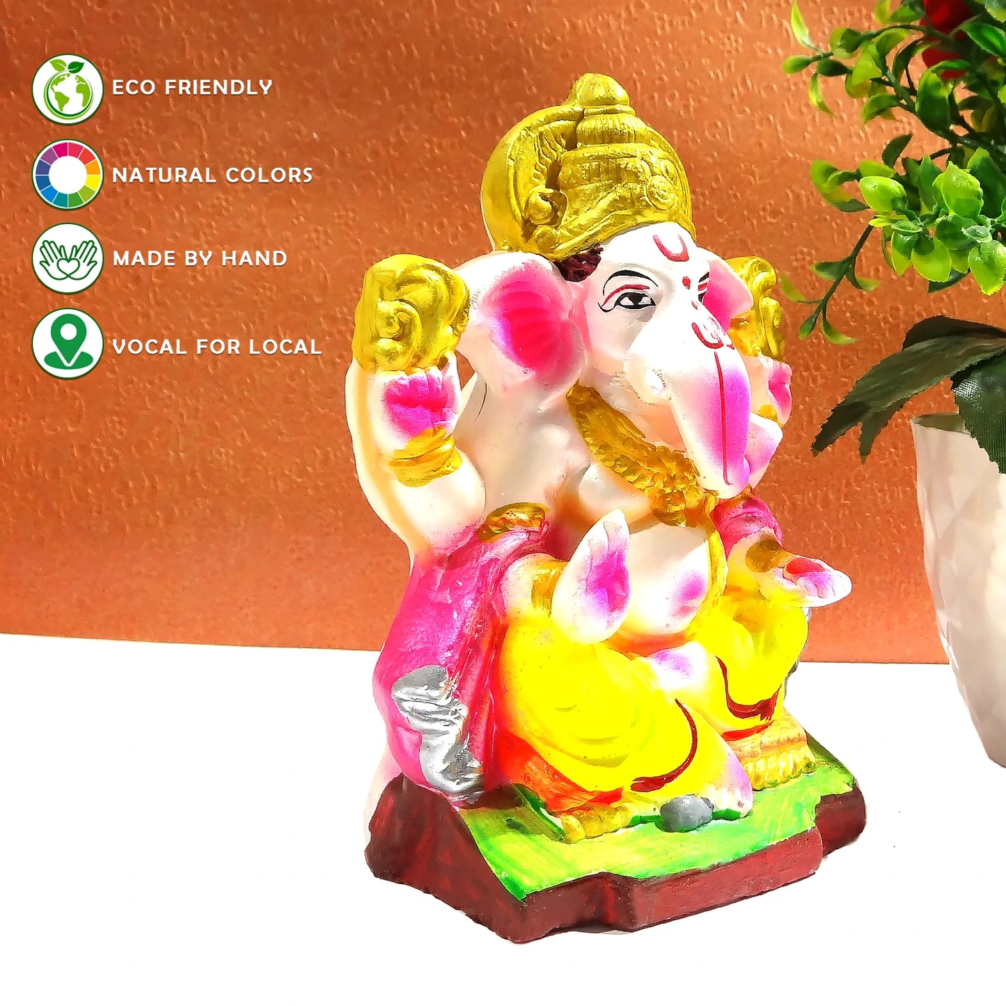 Colorful Ganesha statue with eco-friendly and handcrafted attributes on a white background