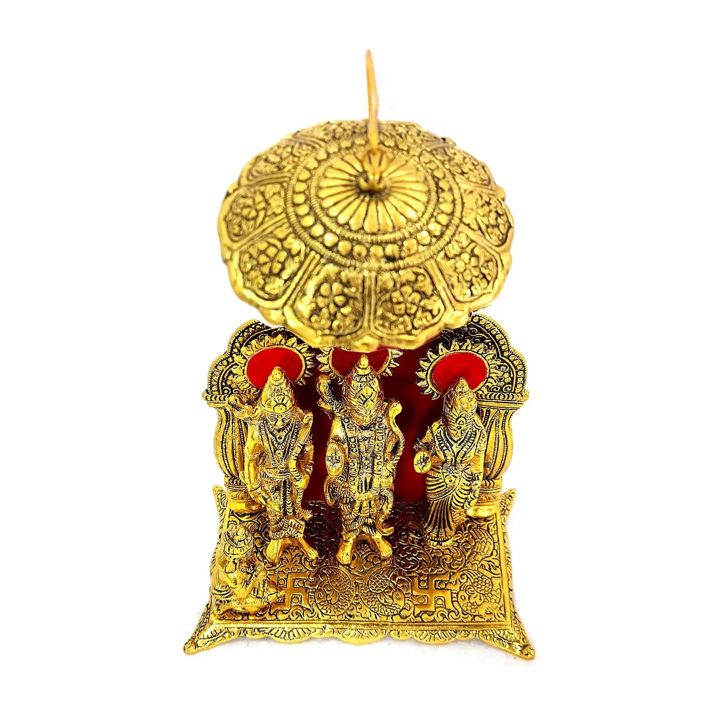 Decorative gold candle with intricate designs and figures on a white background