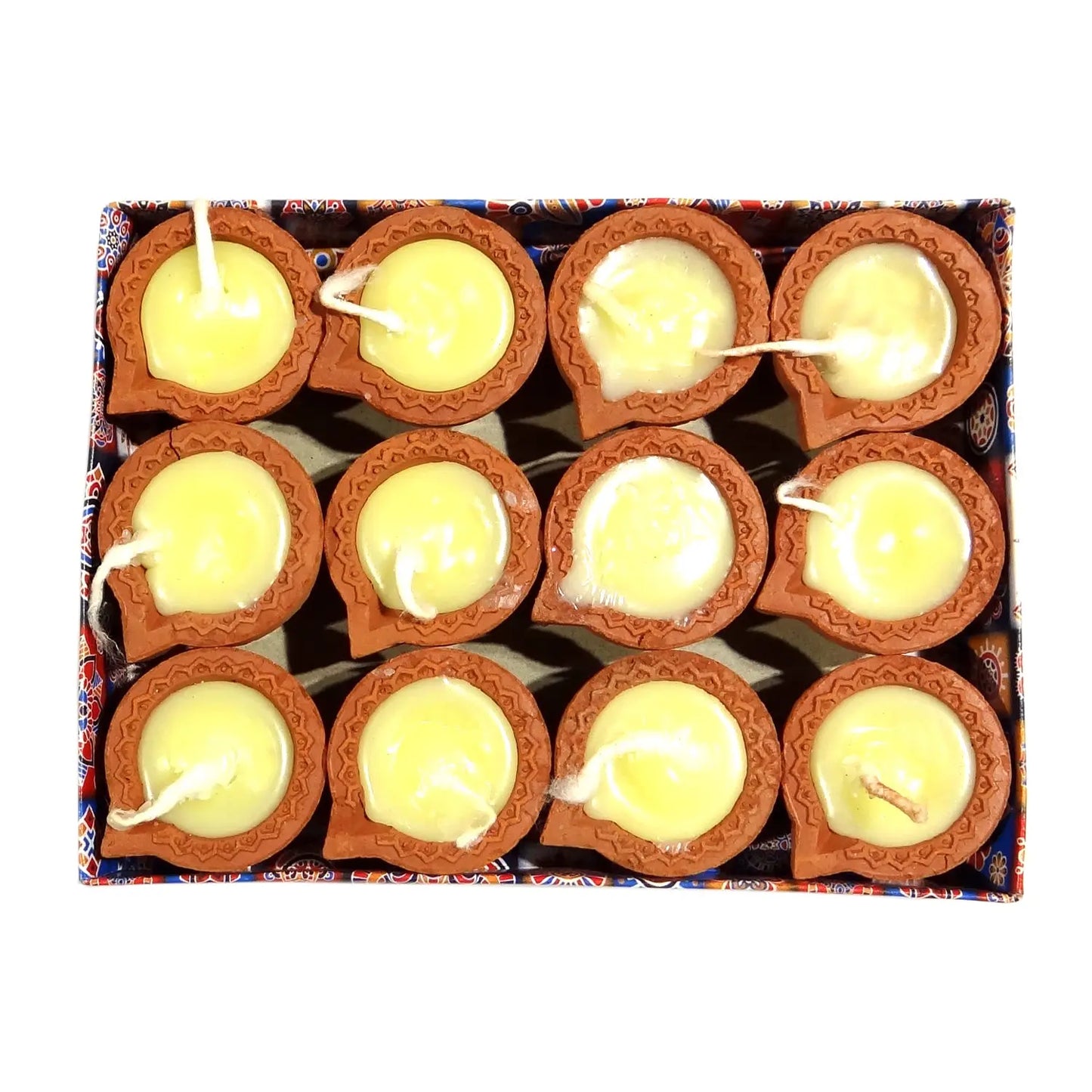 Box of small clay lamps with lit candles inside