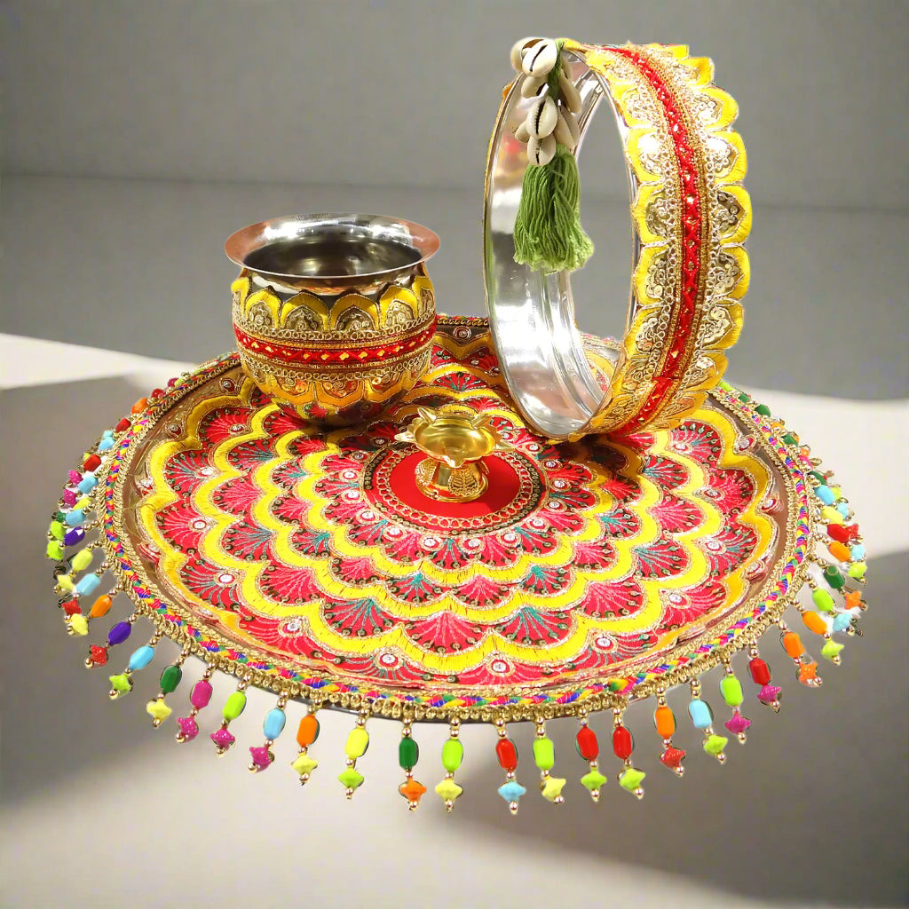 Decorative tray with colorful patterns, a bowl, and a bracelet on a white background