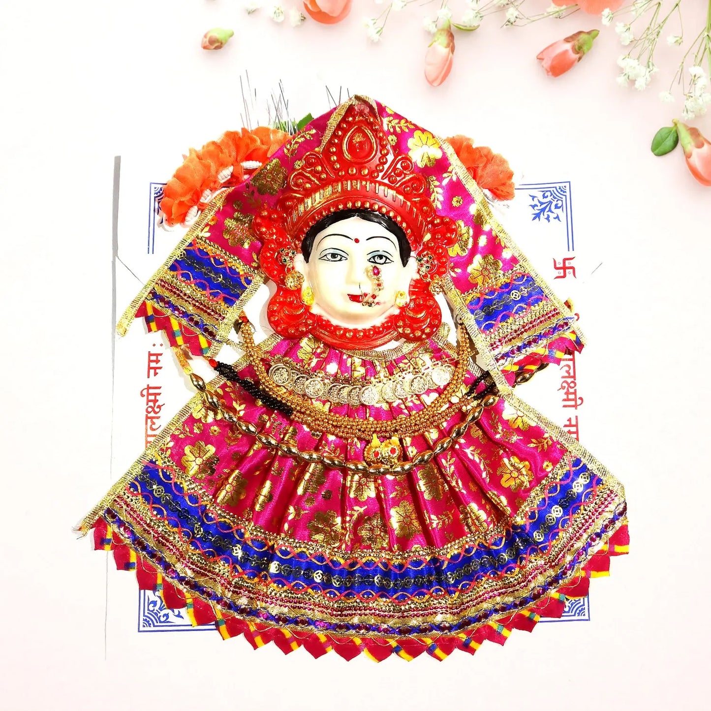 Colorful traditional doll with intricate design on a white background