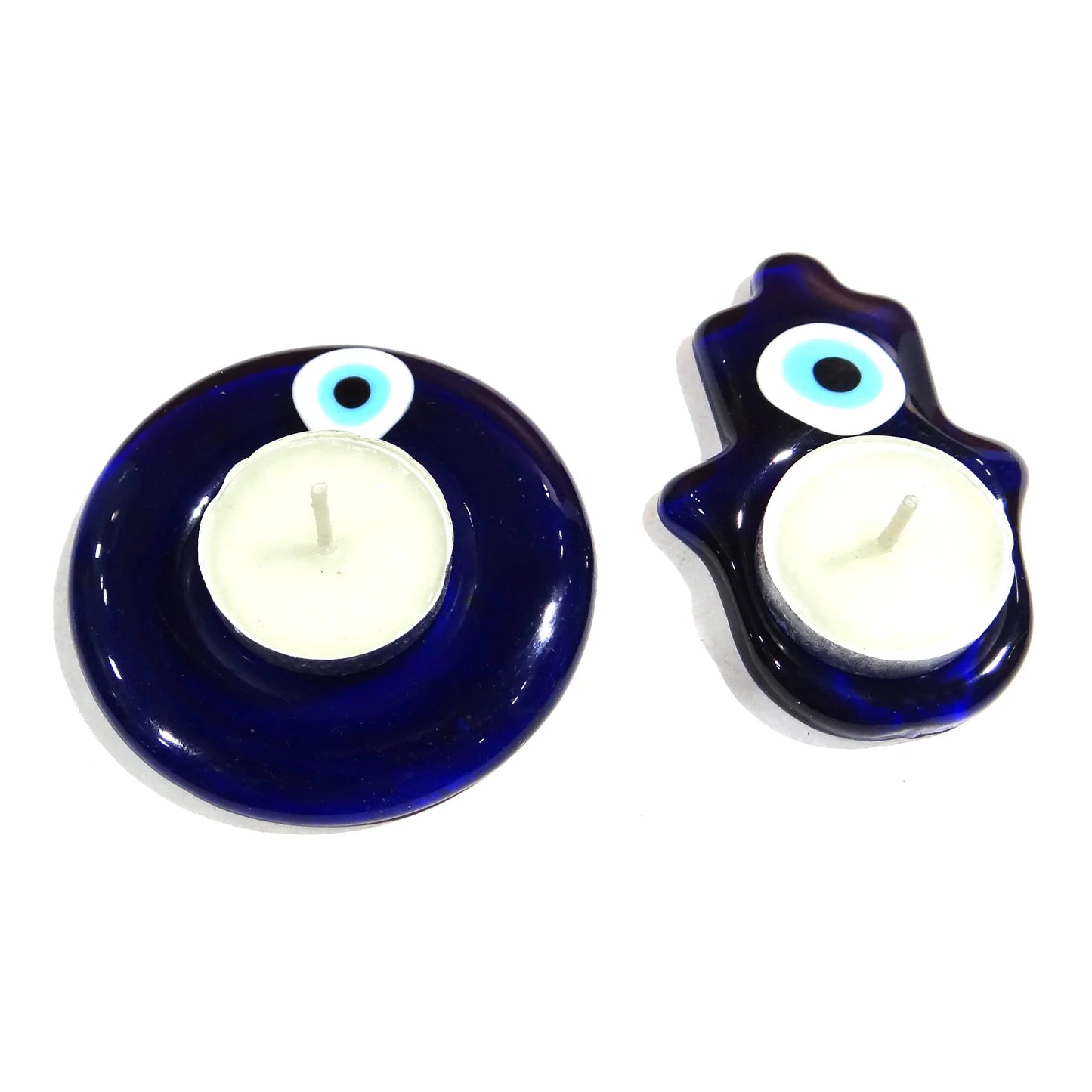 Two blue candle holders with white candles on a white background