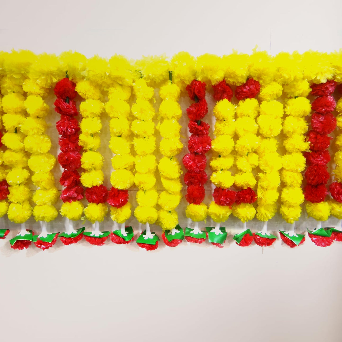 Decorative garland with yellow and red flowers on a white background