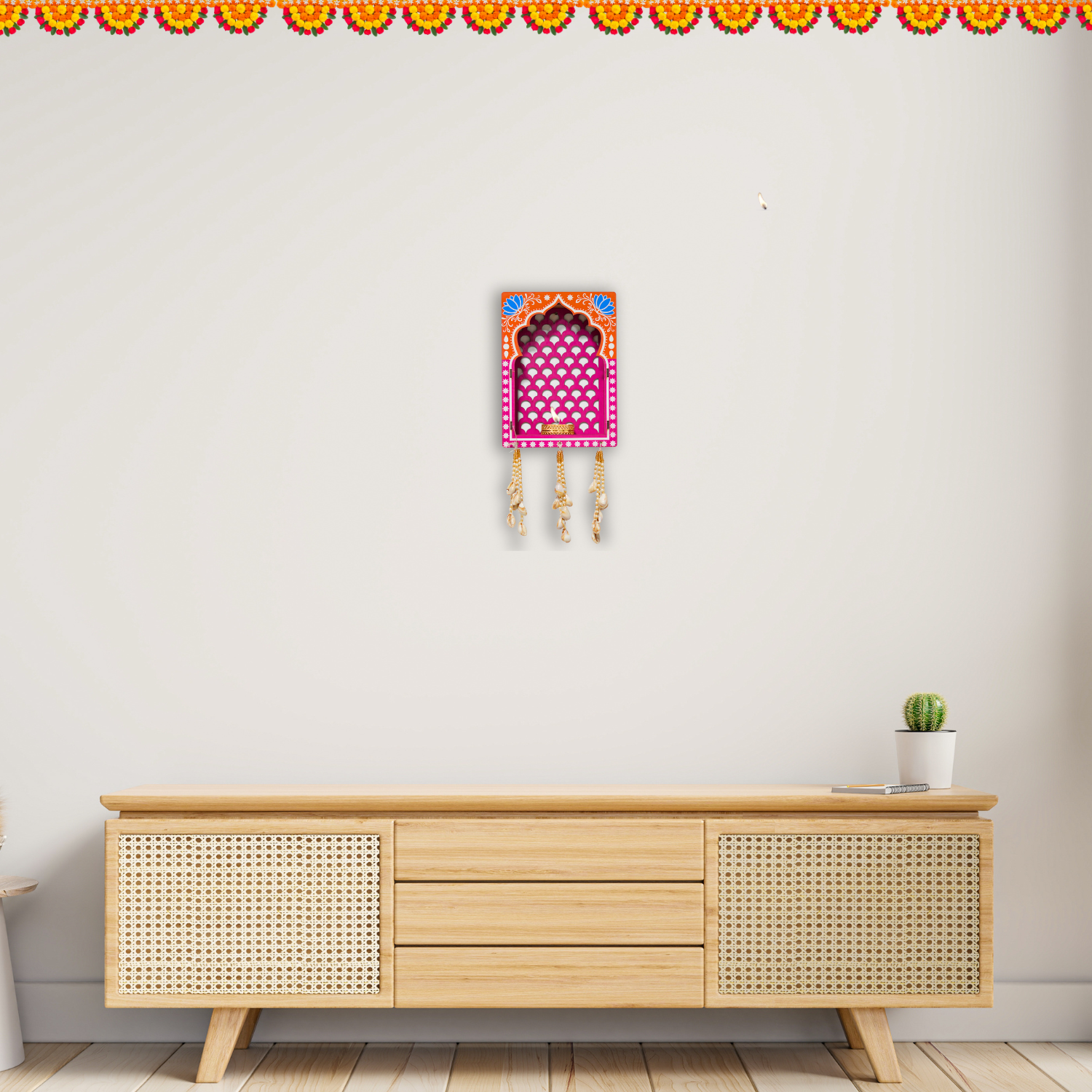 Wooden cabinet with decorative wall art on a plain wall