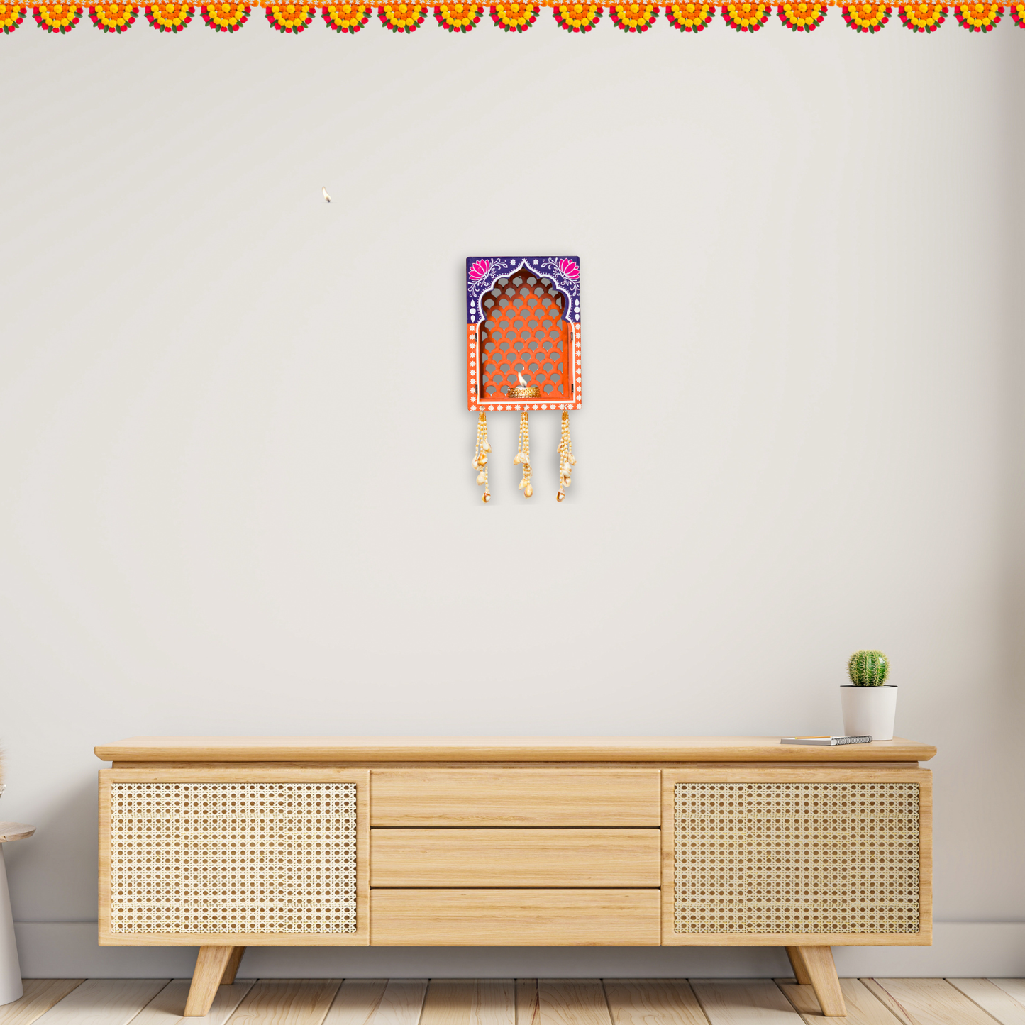 Wooden cabinet with decorative wall art on a plain wall