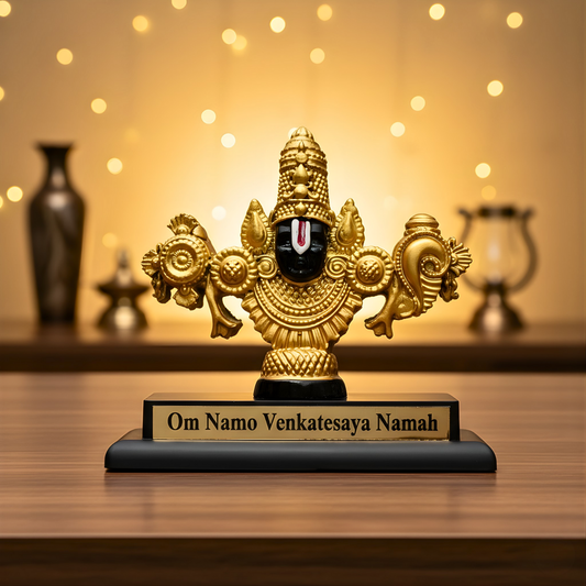 Decorative golden statue with engraved text on a wooden surface