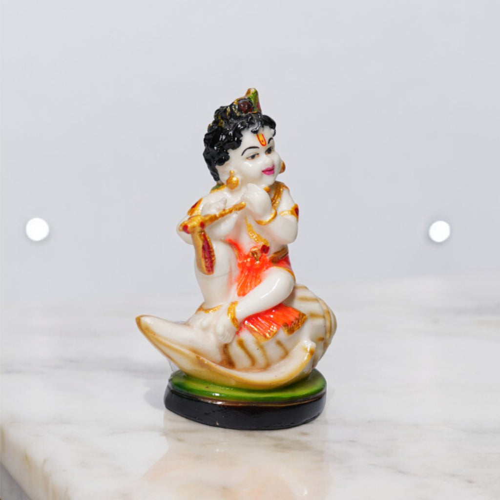 Bal Krishna Playing Bansuri and Sitting on Shankh Sculpture