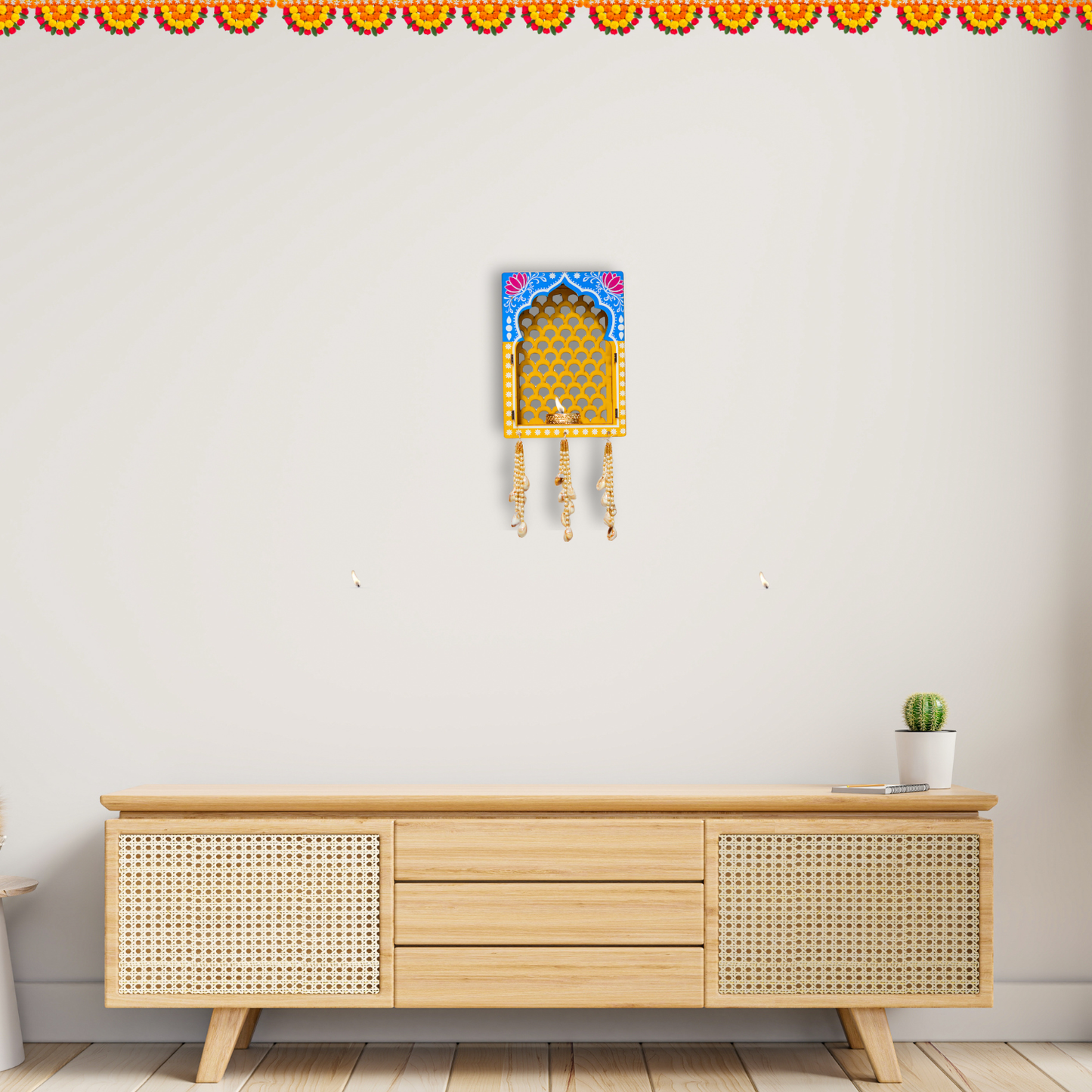 Wooden cabinet with decorative wall art on a plain wall