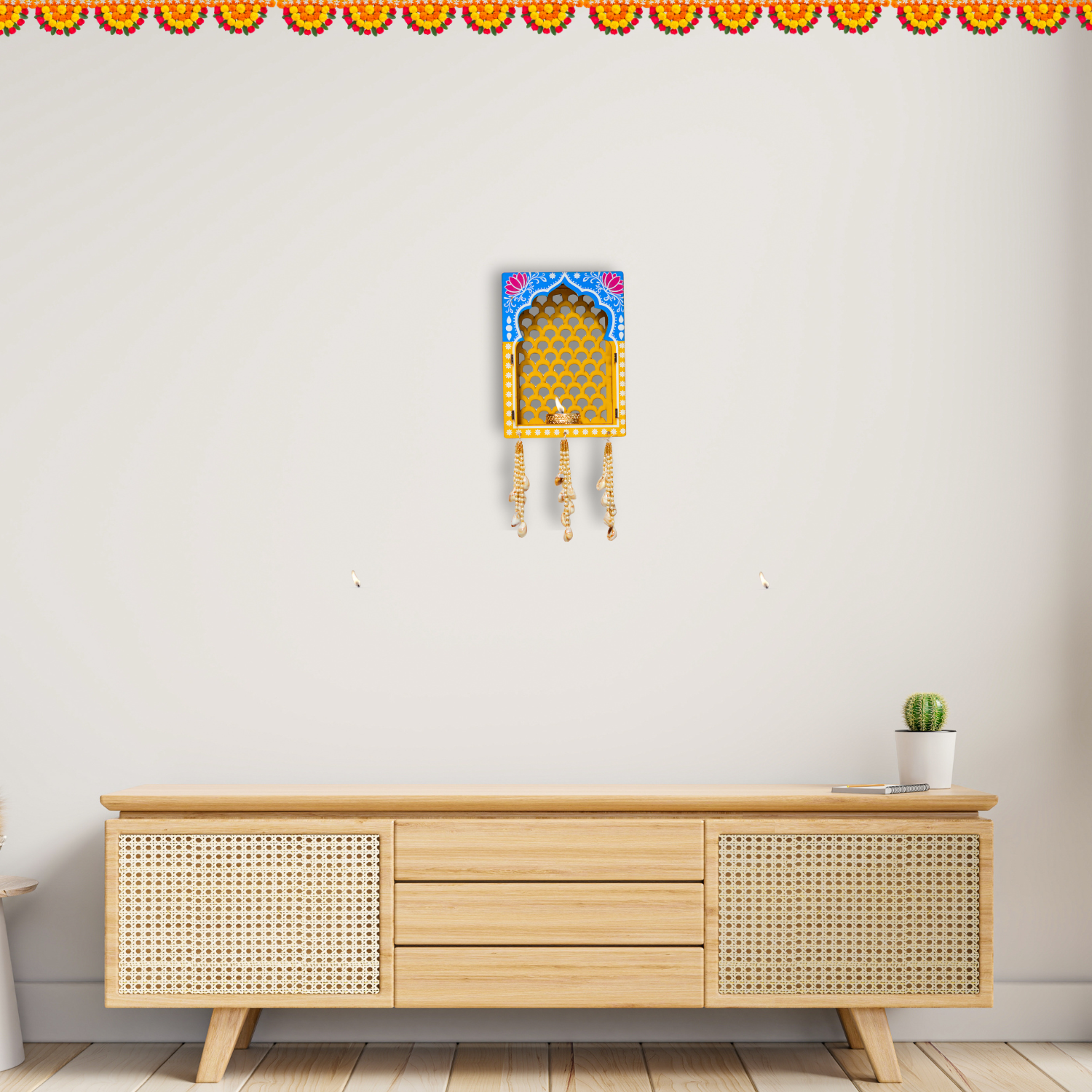 Wooden cabinet with decorative wall art on a plain wall