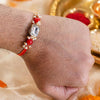 Elegant Handcrafted Stone Rakhi with Vibrant Red Beads and Golden Charms By Upharkaro