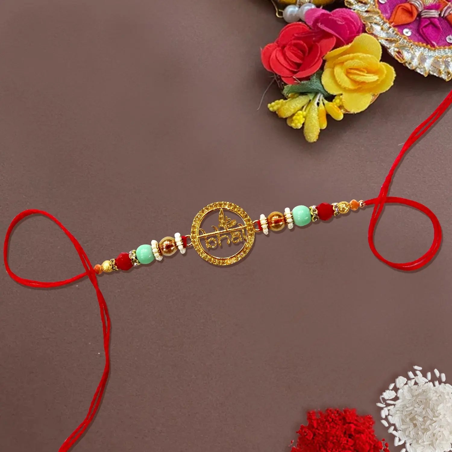 Decorative bracelet with beads and red string on a brown background
