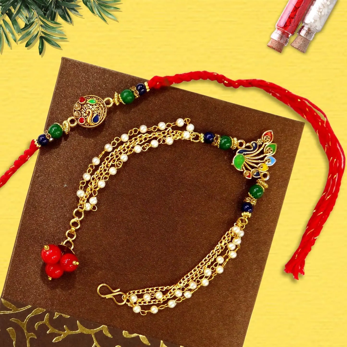 Gold anklets with colorful beads on a brown card against a yellow background