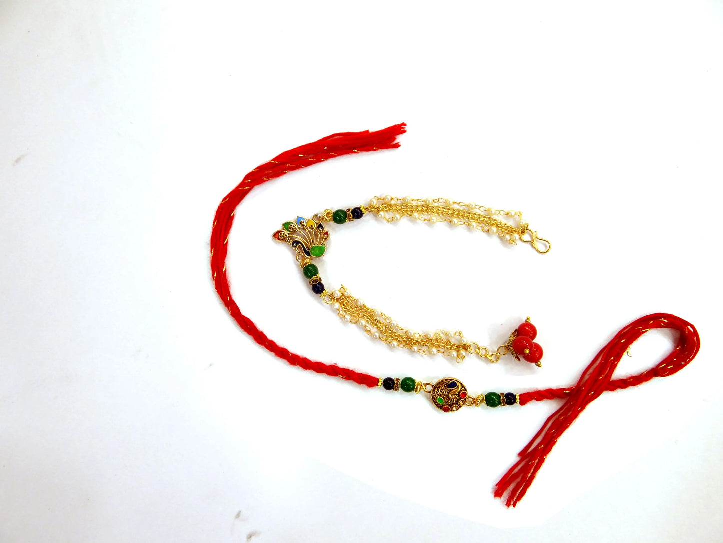 Gold necklace with red tassels on a white background