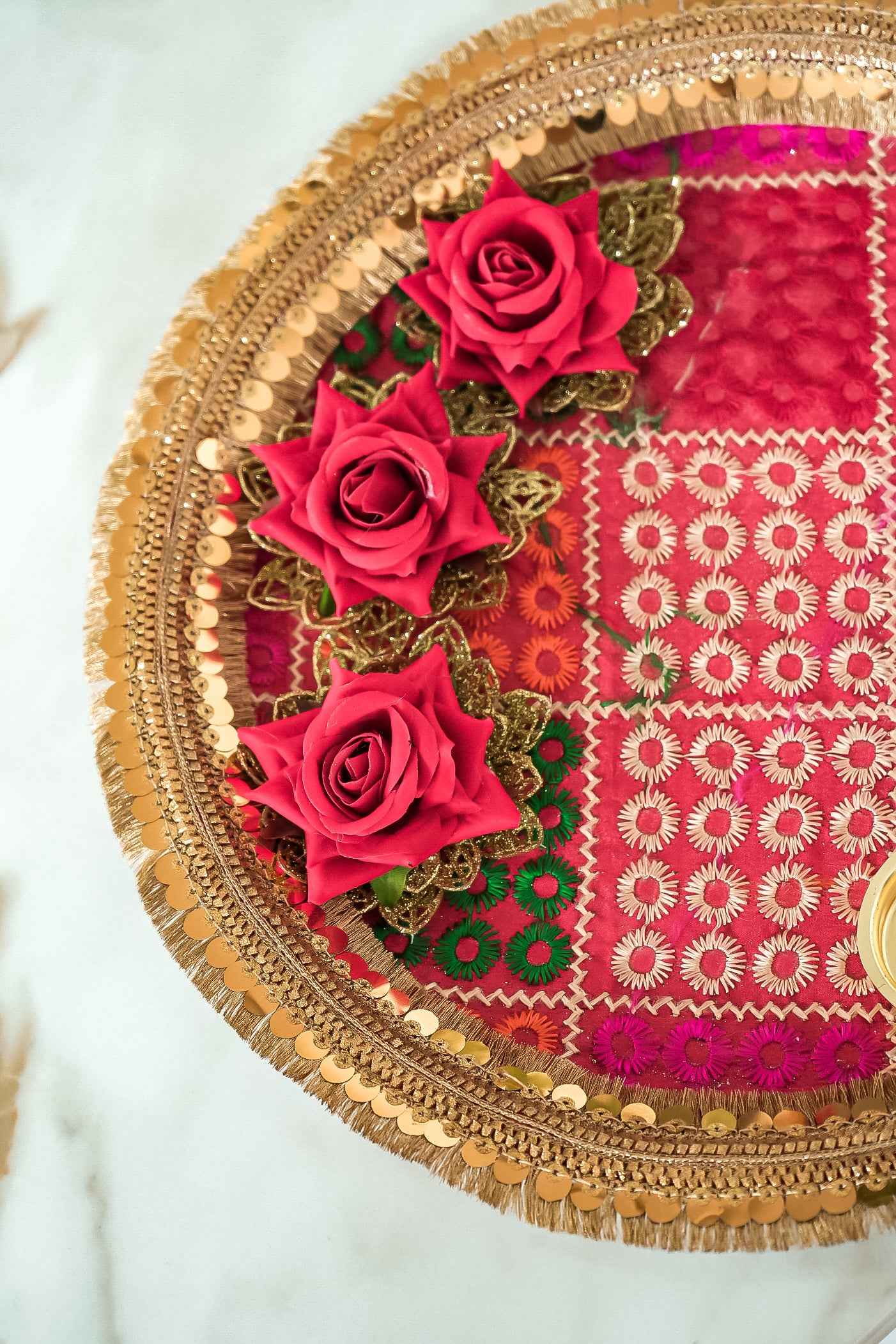 Decorative tray with red roses and gold embroidery on a white background