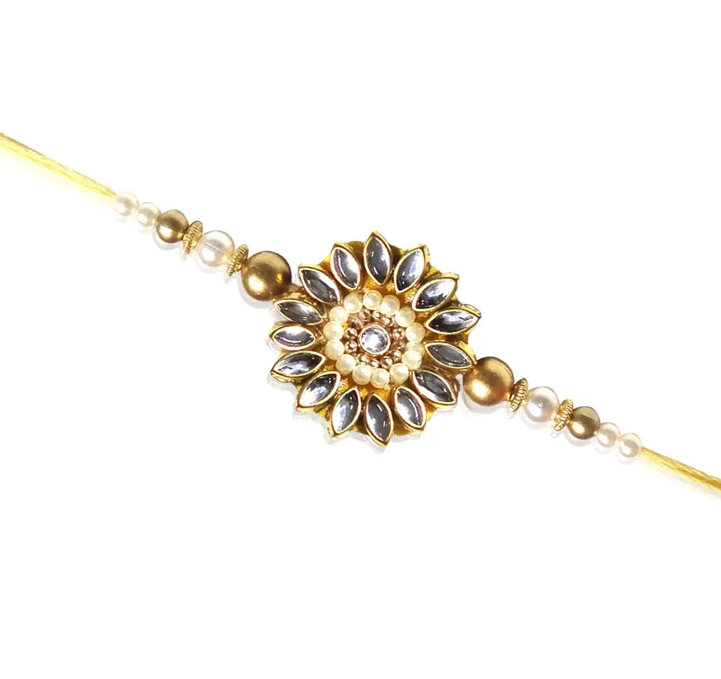 Decorative gold and pearl bracelet on a white background
