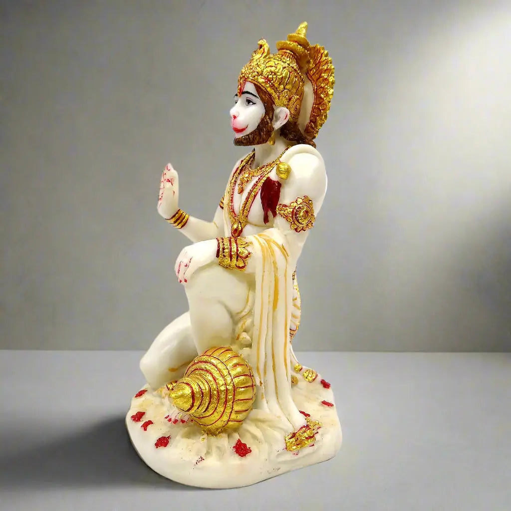 Statue of a deity with gold and white details on a gray background