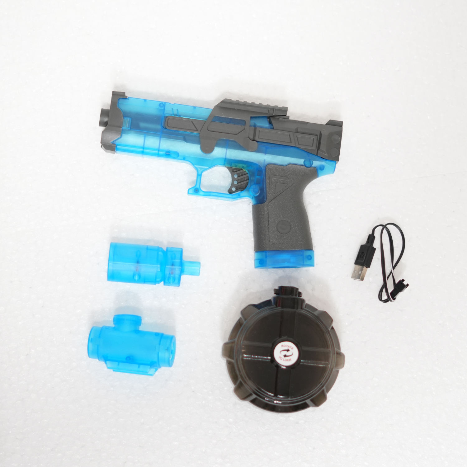 Toy gun with blue and gray design, USB cable, and black circular component on a white background