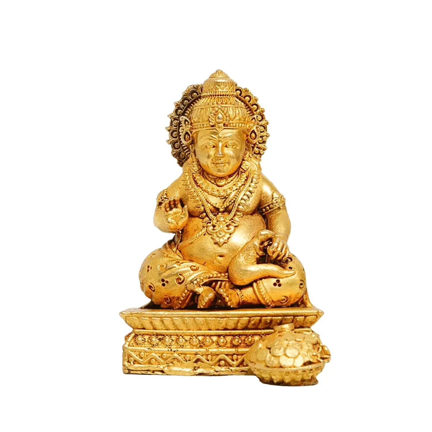 Gold-colored statue of a seated figure with intricate details on a white background