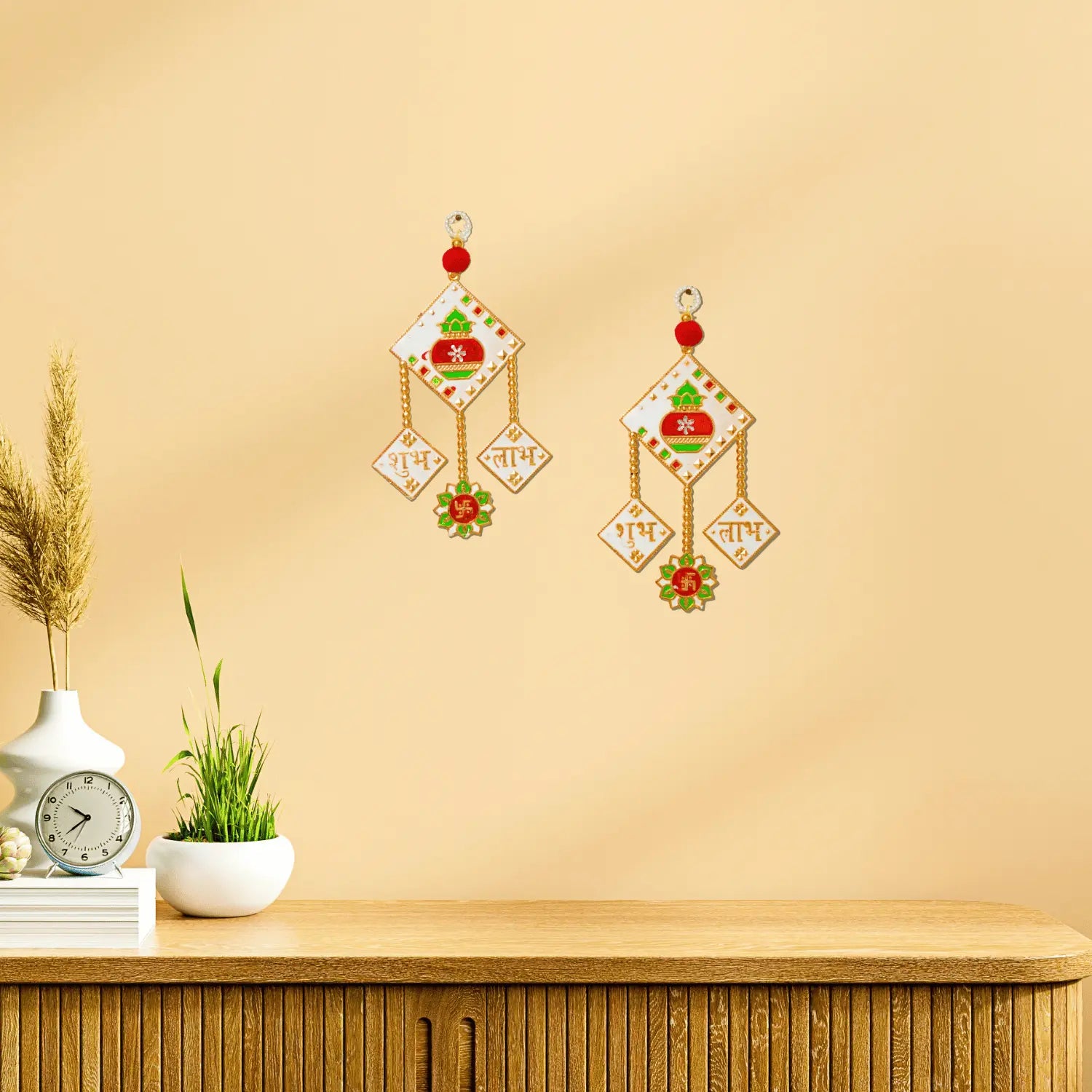 Decorative wall stickers on a beige wall with a wooden shelf and plant.