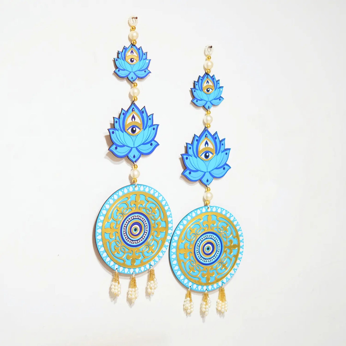 Blue lotus flower earrings with circular designs on a white background