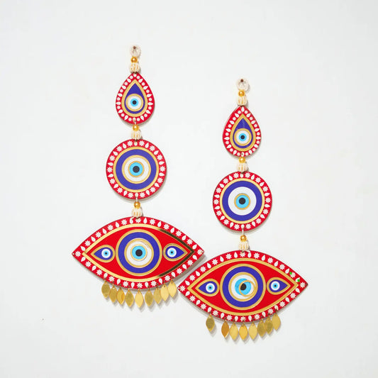 Colorful eye-shaped earrings with red, blue, and gold design on a white background