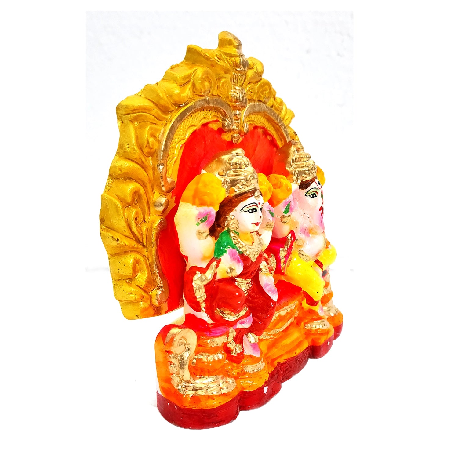 Decorative statue with gold and red elements on a white background