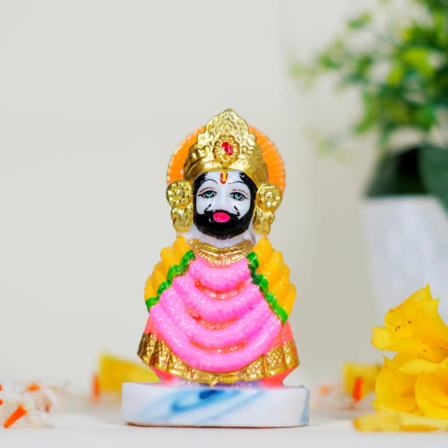 Colorful figurine of a deity with a blurred background