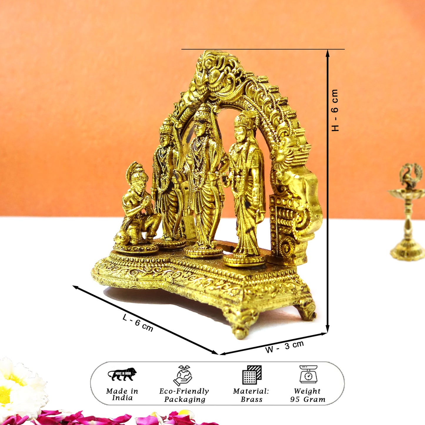 Decorative gold statue with measurements on an orange background