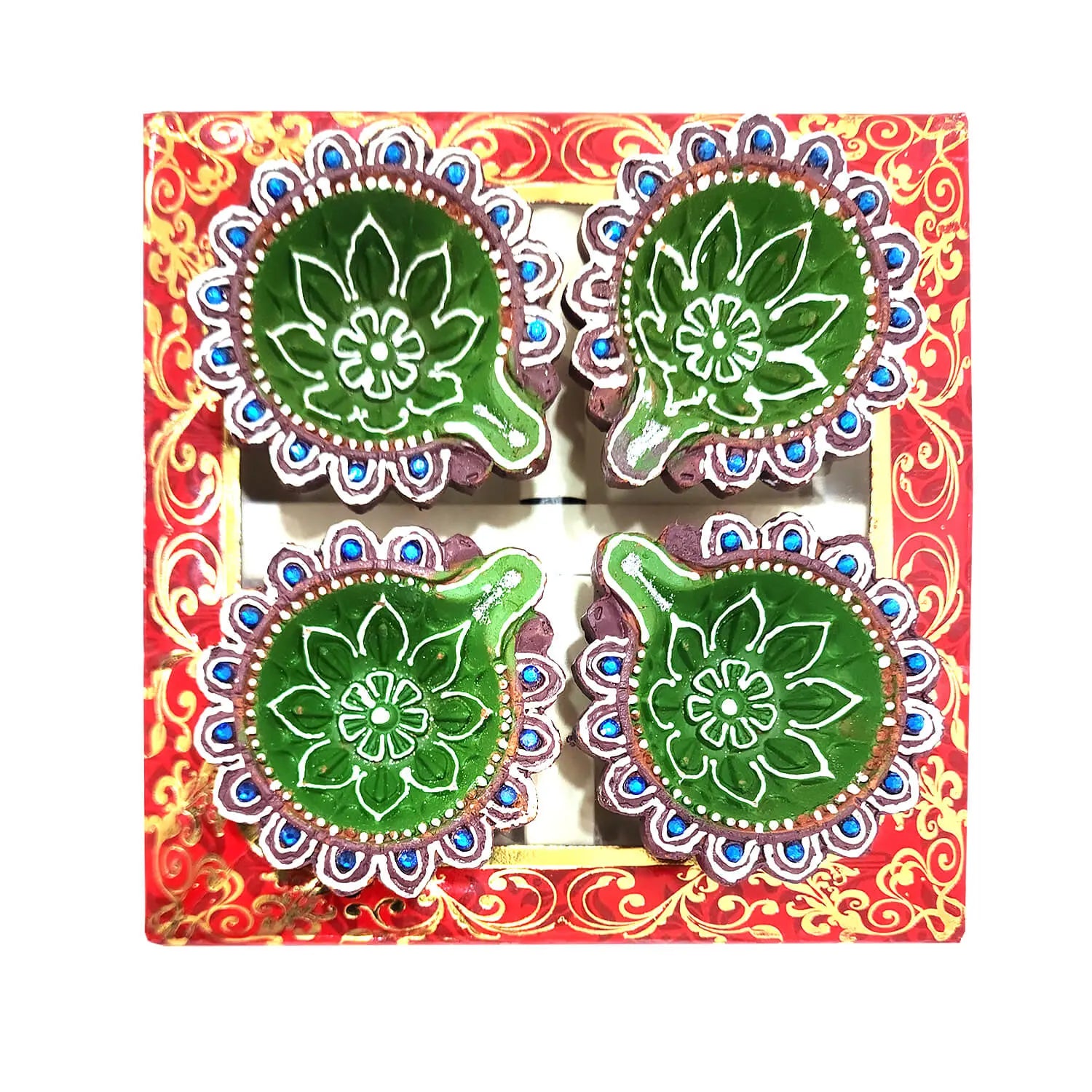 Decorative diya set with green designs in a colorful box