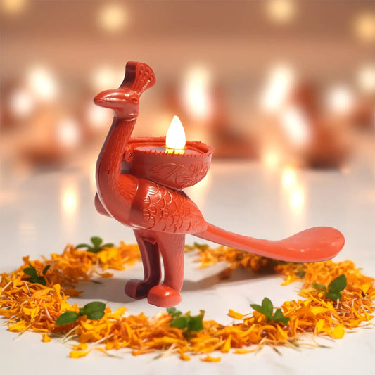 Decorative peacock shaped led bulb diya, a blurred background.