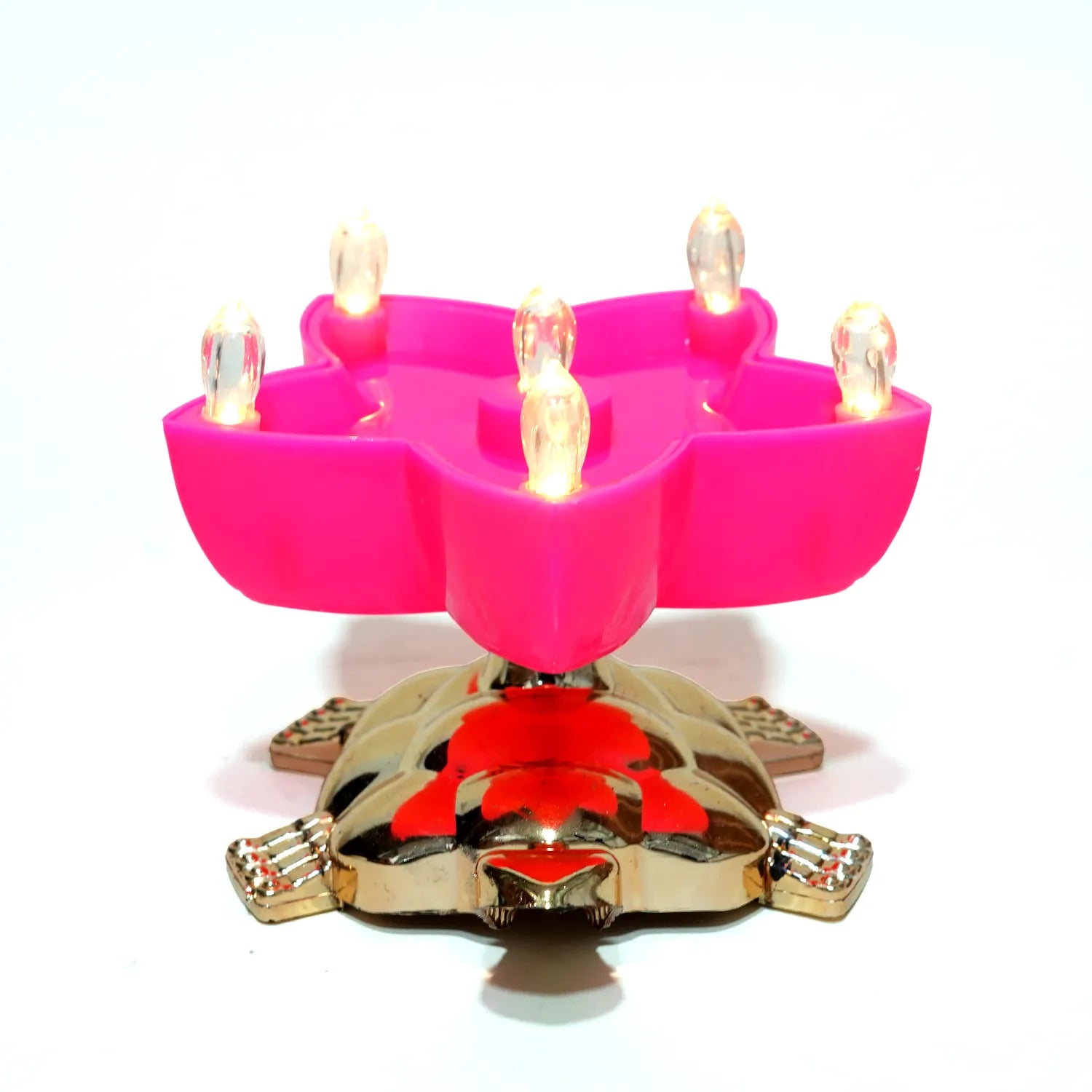 Pink candle holder with lit candles on a white background