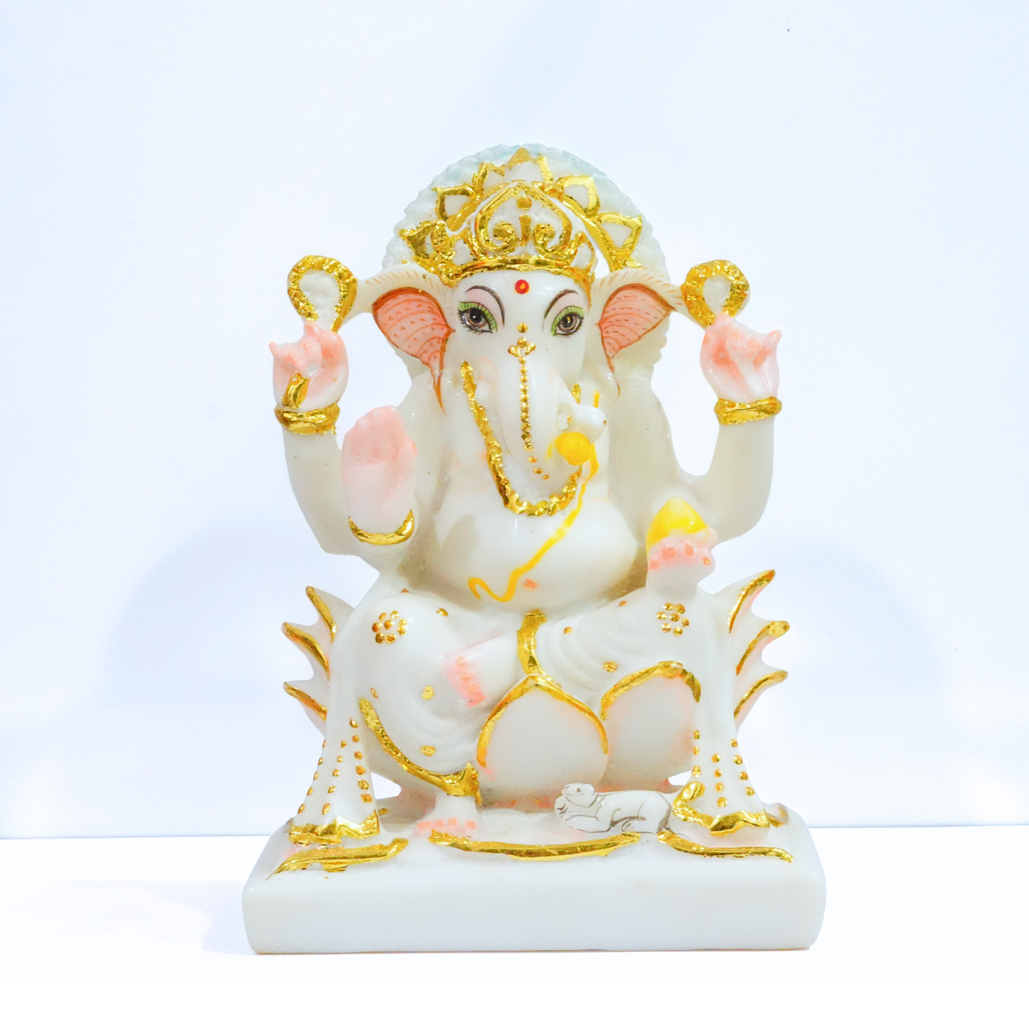 Decorative statue of a deity with gold and pink accents on a white background