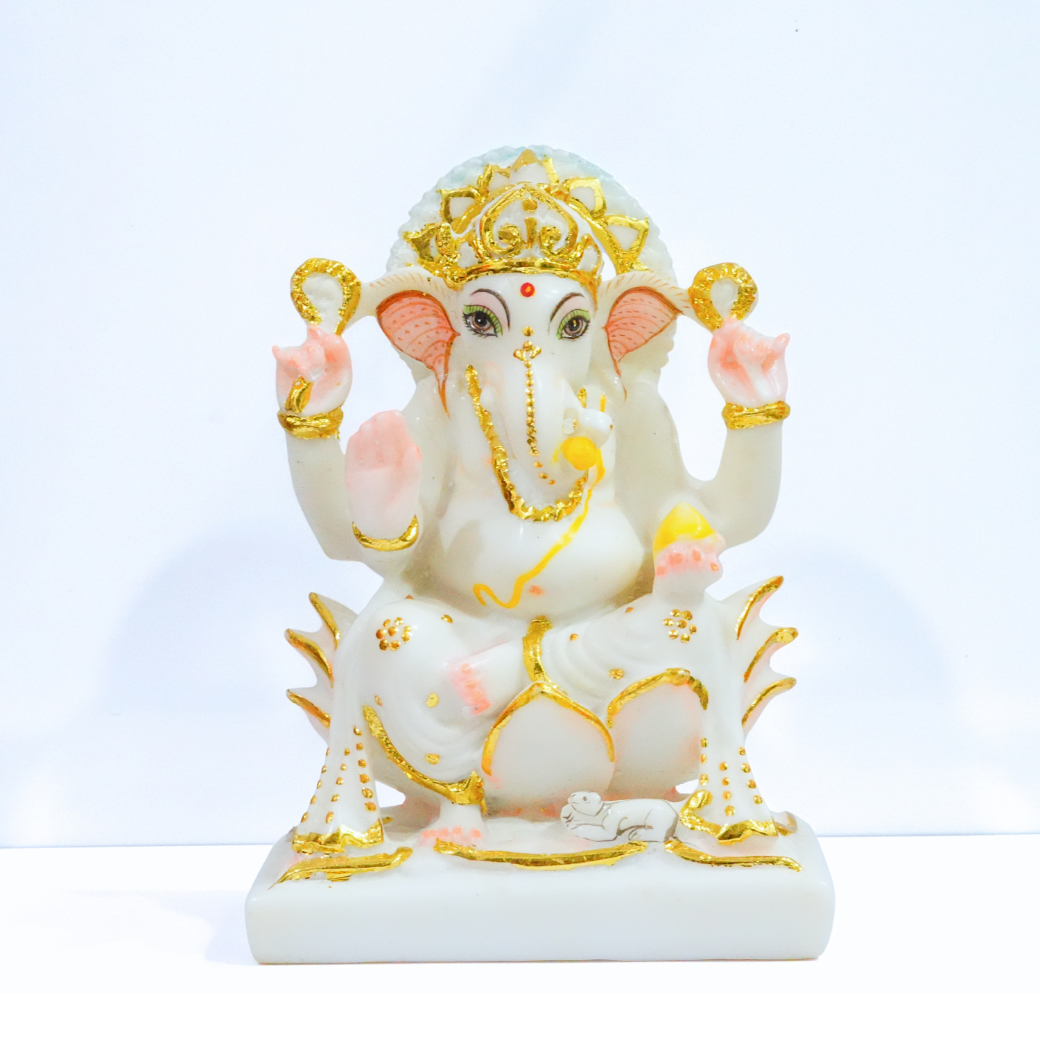 Decorative statue of a deity with gold and pink accents on a white background
