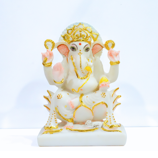 Decorative statue of a deity with gold and pink accents on a white background