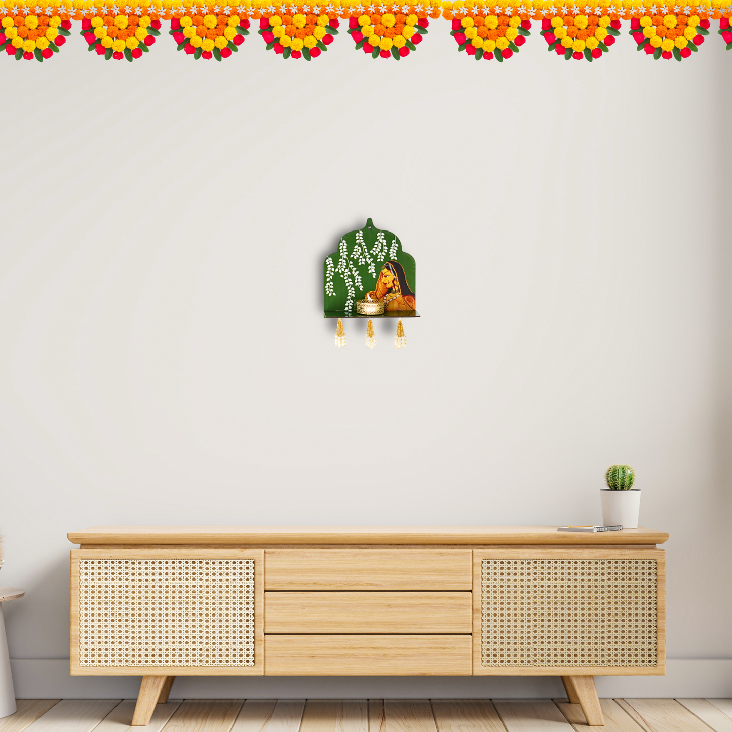 Decorative wall hanging above a wooden cabinet with a white wall and floral border.