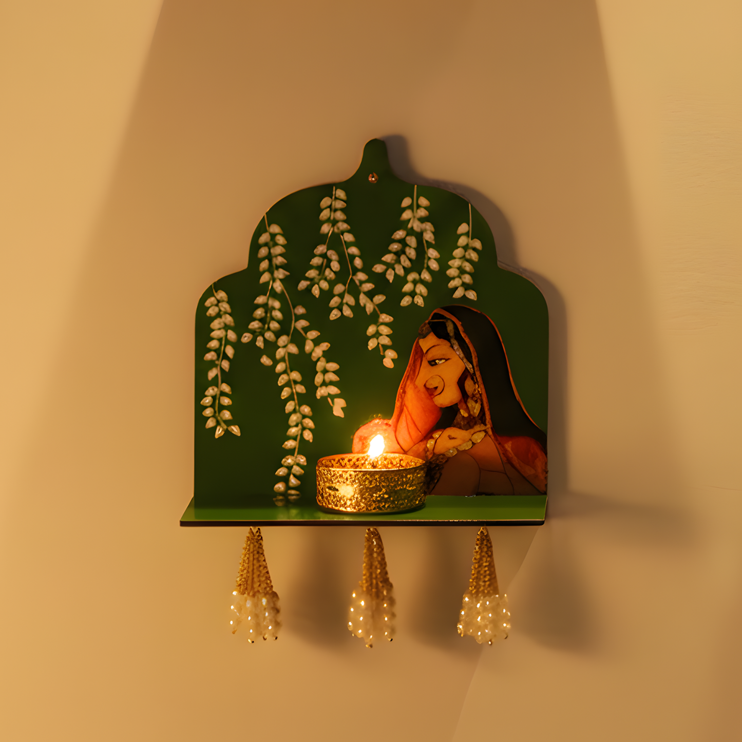 Decorative wall shelf with a painting of a woman, a lit candle, and hanging decorations on a beige wall.