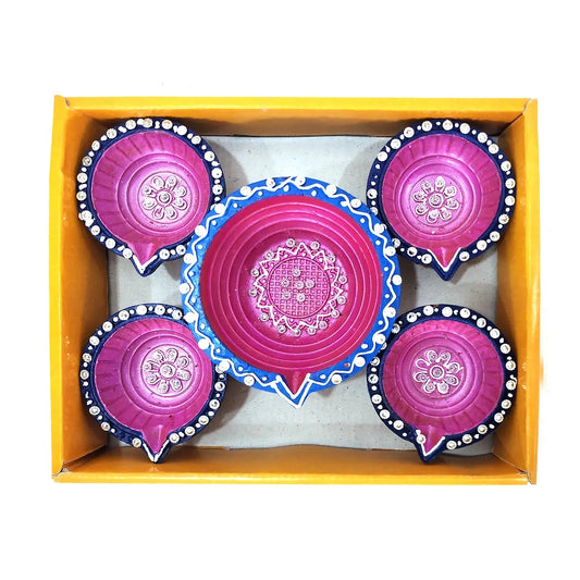 Set of pink and blue decorative items in a yellow box
