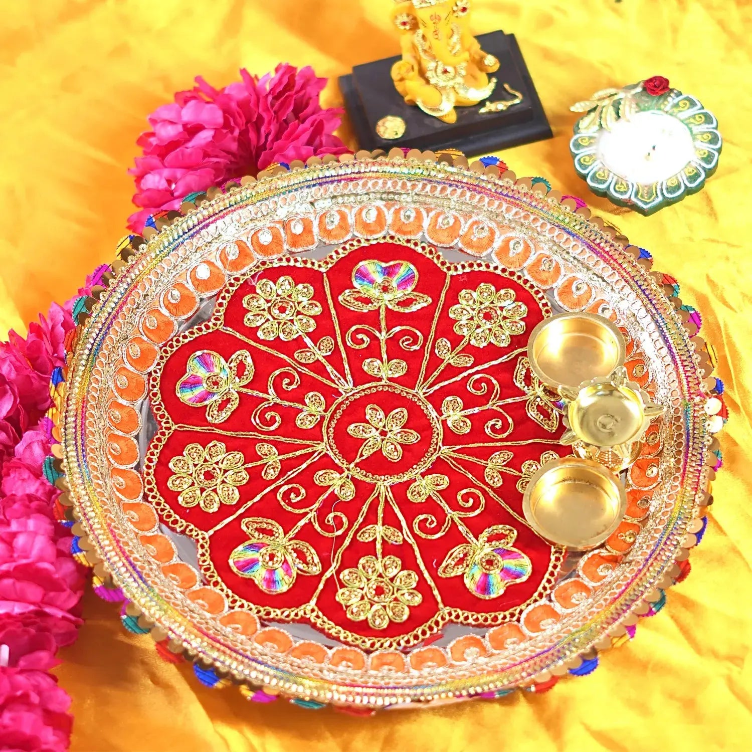 Decorative plate with gold and red design on a yellow background