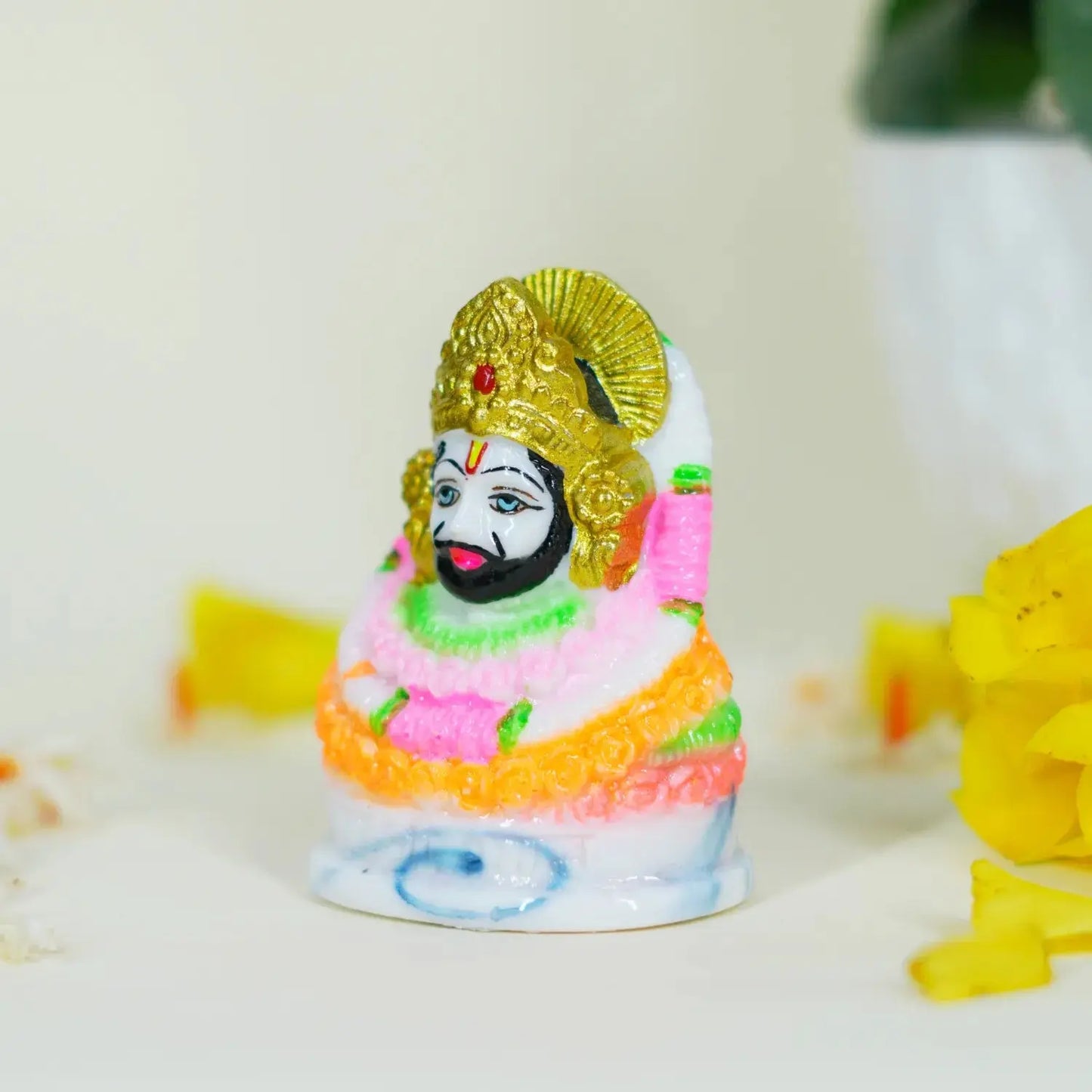 Colorful figurine with a gold headdress on a white background
