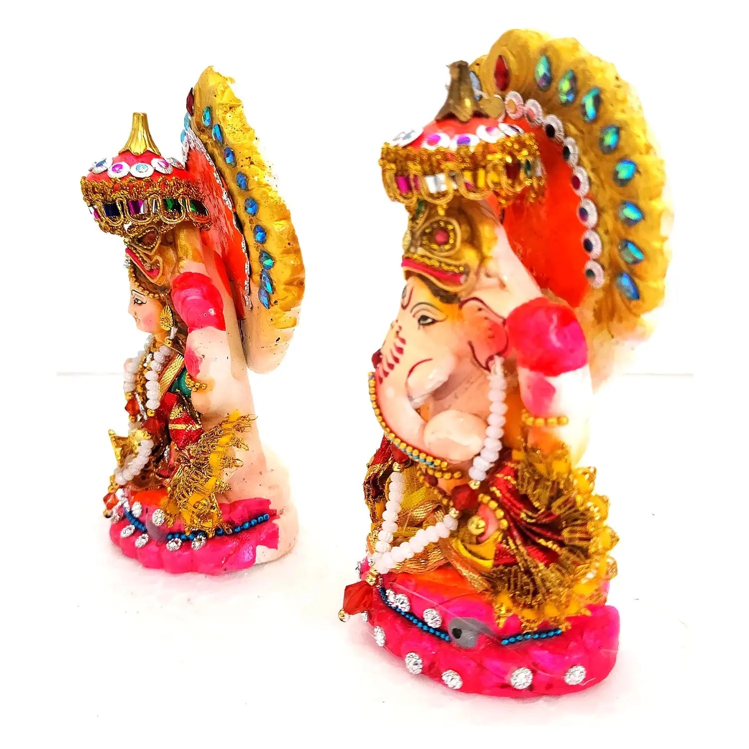 Decorative statue of a deity with colorful attire and accessories on a white background