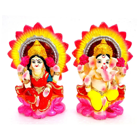 Two colorful figurines of a deity with a bright background