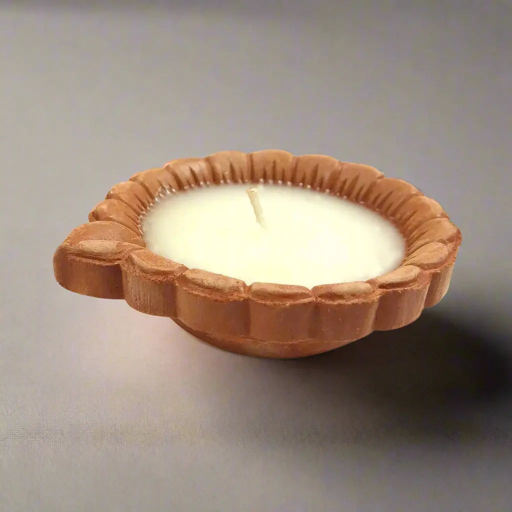 Candle in a decorative wooden holder on a white background