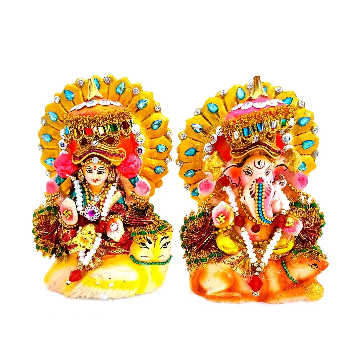 Decorative statues of a deity and a elephant-headed figure with colorful attire on a white background