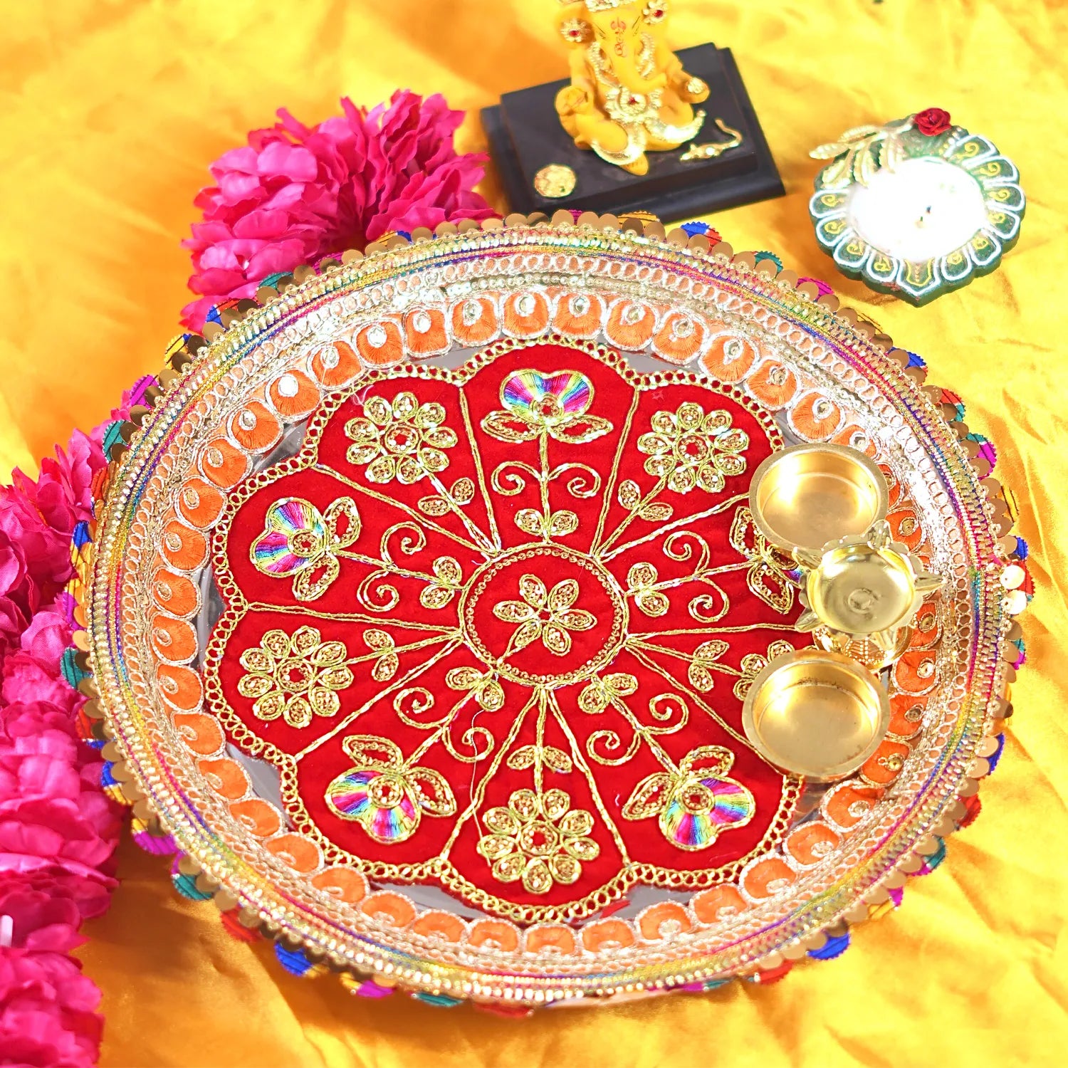 Decorative plate with gold and red design on a yellow background