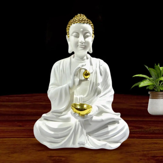 White Buddha statue with gold accents holding a bowl on a wooden surface.