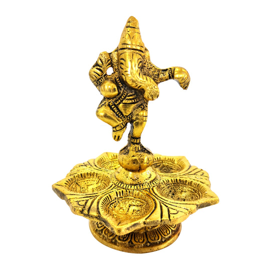 Gold-colored elephant statue on a decorative platform with intricate designs