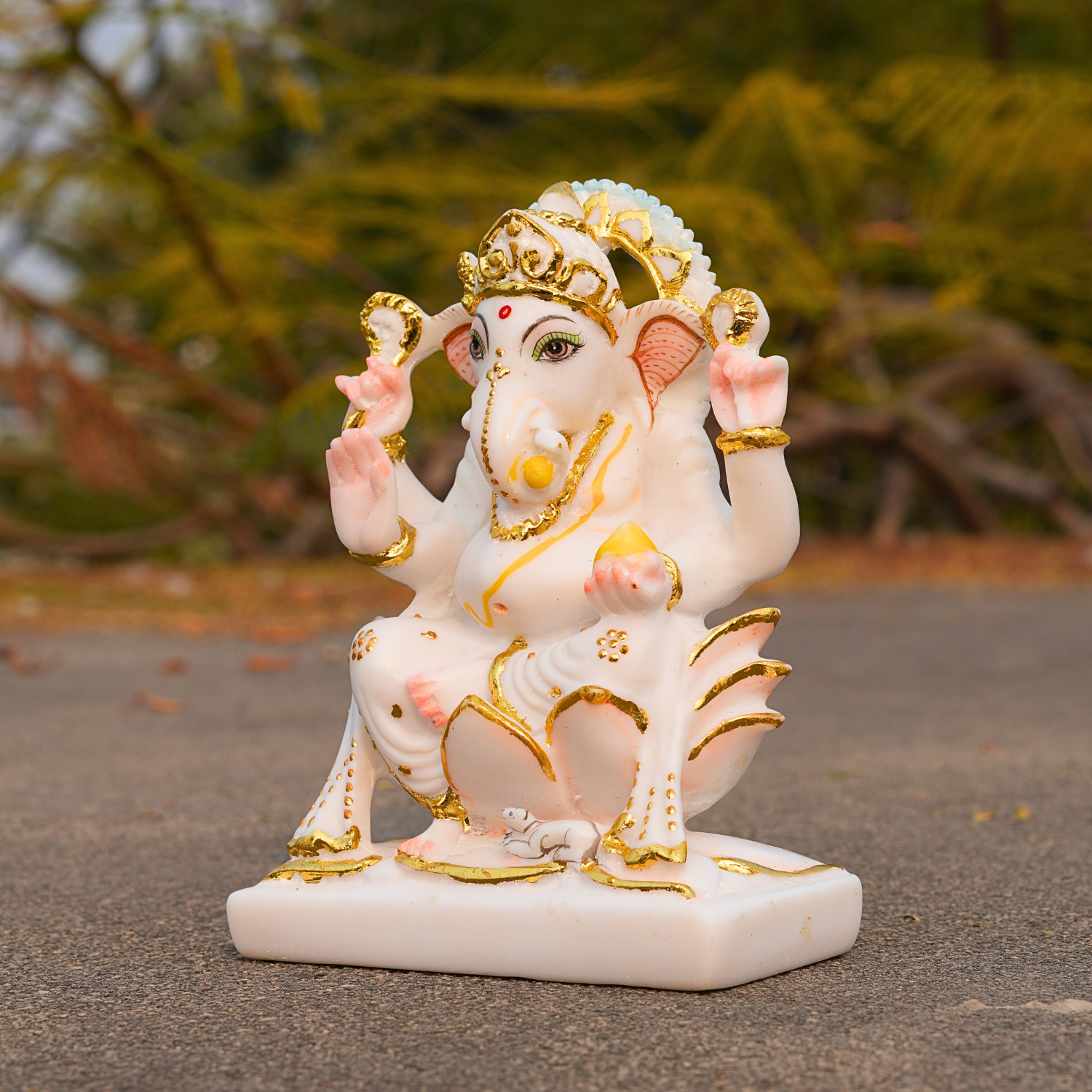 Decorative statue of a deity on a blurred natural background