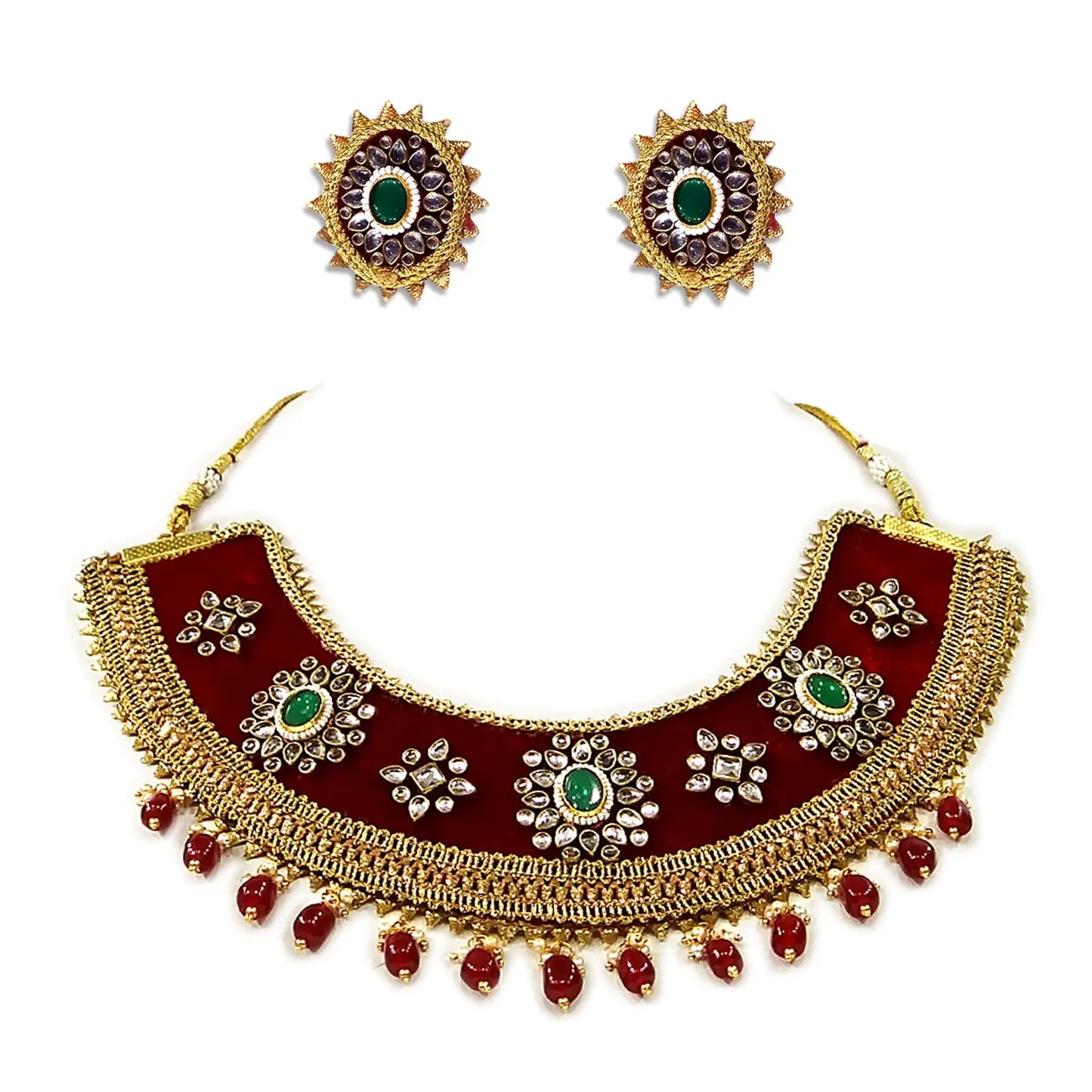 Ornate necklace and earrings set with gold, red, and green details on a white background