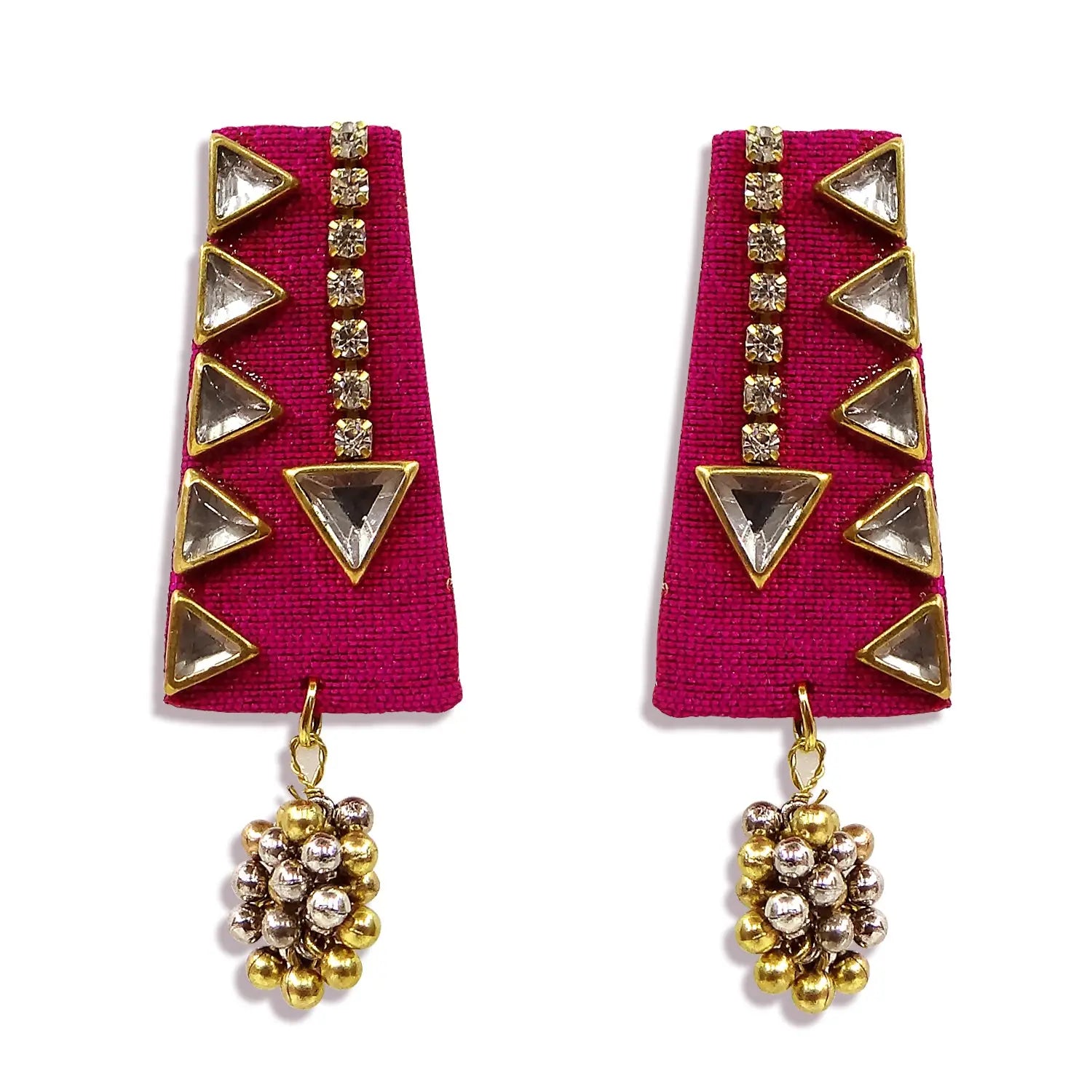 Pair of earrings with pink fabric backing and gold and silver geometric design on a white background