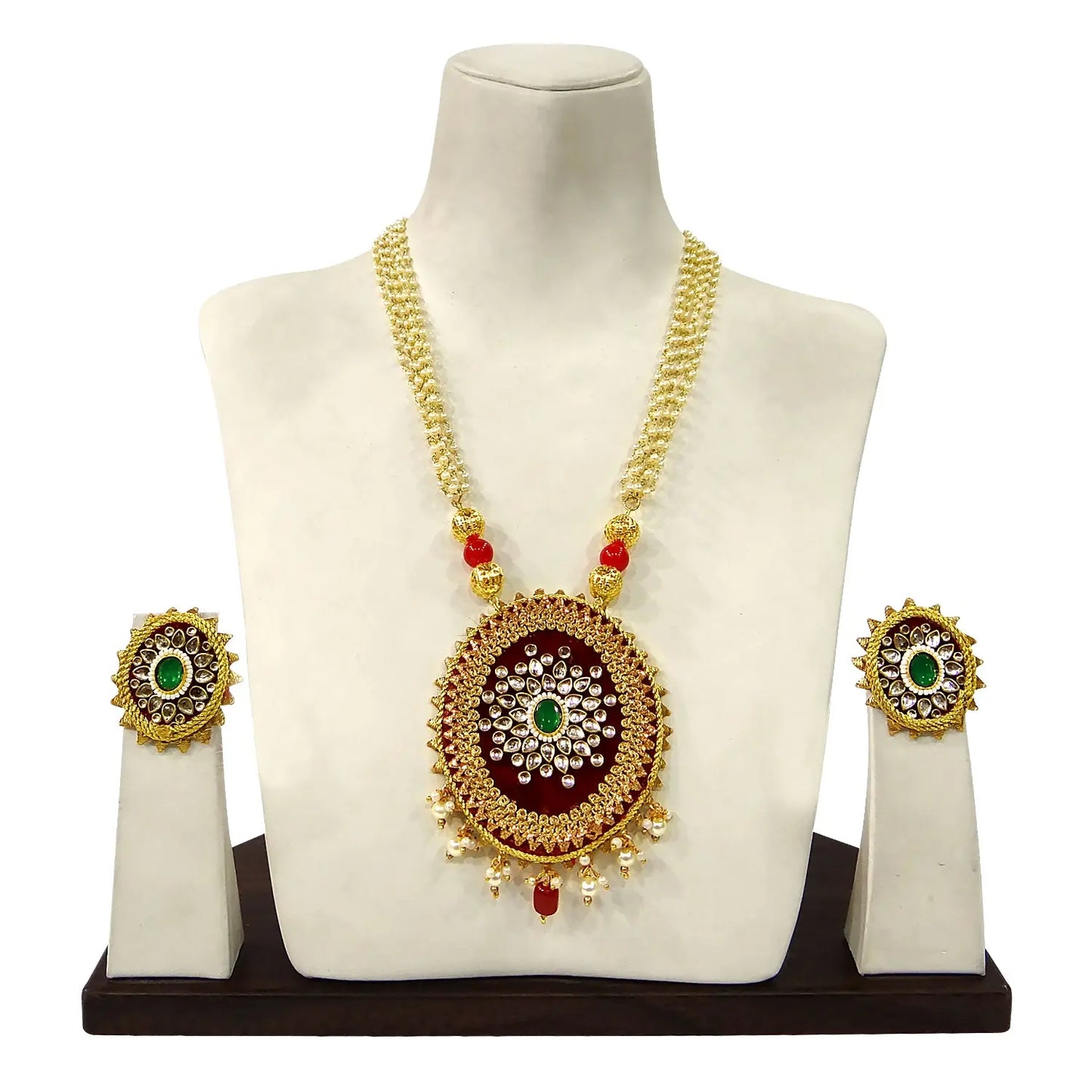 Gold necklace with pendant and earrings on a mannequin bust